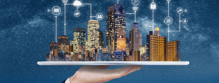 Smart city, building technology, and real estate business. Businessman holding digital tablet with buildings hologram and application programming interface technology